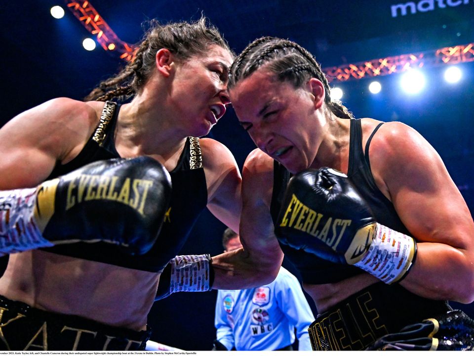 25 November 2023; Katie Taylor, left, and Chantelle Cameron during their undisputed super lightweight championship bout at the 3Arena in Dublin. Photo by Stephen McCarthy/Sportsfile