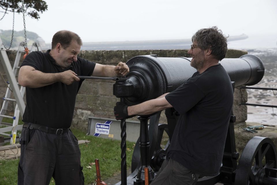 External conservators Matthew Packer (left) and Tim Martin, as they install a cannon, made in 1826, on its return to Berwick-Upon-Tweed Barracks following major conservation (English Heritage/PA)