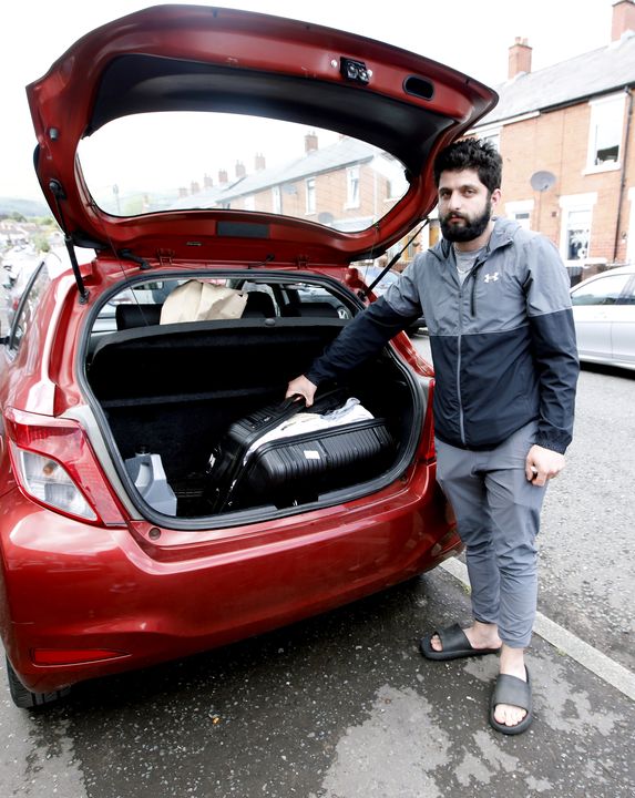 Jamal with a suitcase containing all his belongings