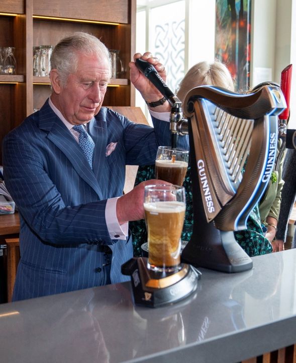 Britain's Prince Charles pours a pint of Guinness as he visits the Irish Cultural Centre with Camilla, Duchess of Cornwall, to celebrate the centre's 25th anniversary in the run-up to St Patrick's Day, in London on March 15, 2022. Photo: Arthur Edwards/Pool