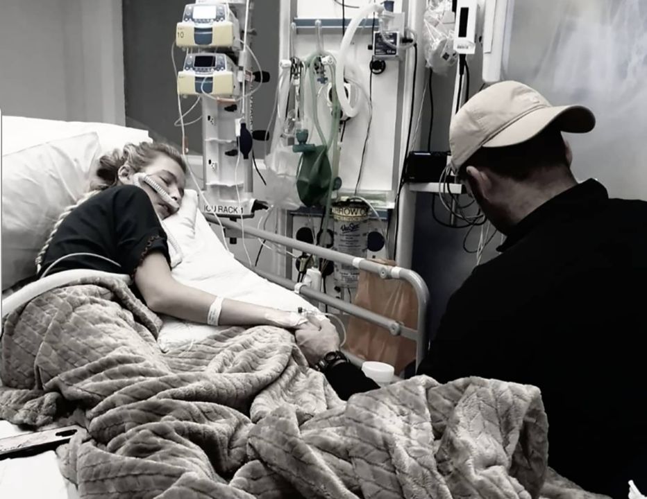 Nicole, in hospital when ill with partner Ciaran, holding her hand.
