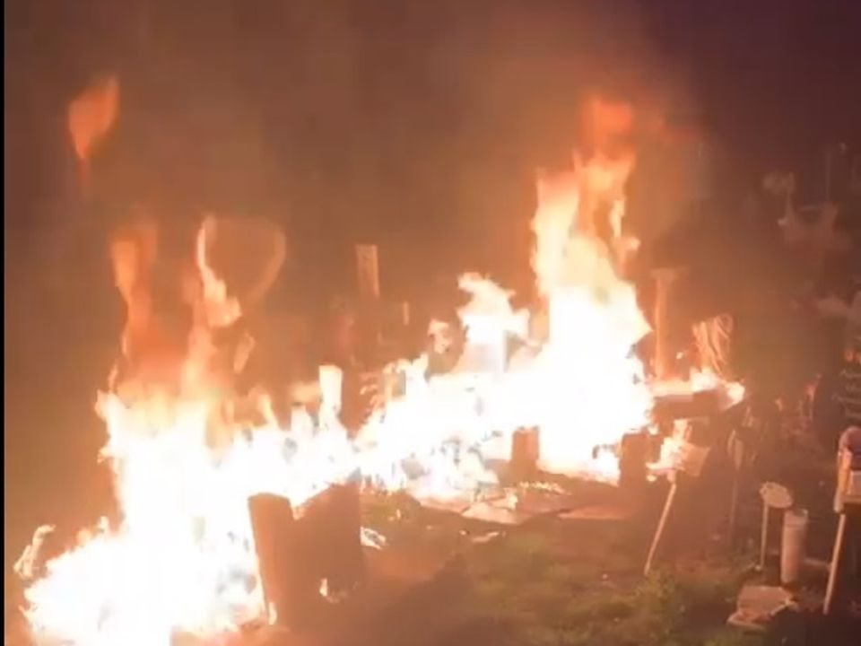Video grab of a grave set alight as a part of a bitter family feud