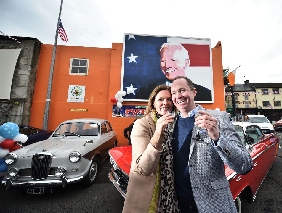 Joe Blewitt, a third cousin of US President Joe Biden, celebrates with his wife Deirdre in front of a mural of the President after his election in November 2020. President Biden's ancestors hail from the Co Mayo town of Ballina. Photo: Charles McQuillan/Getty