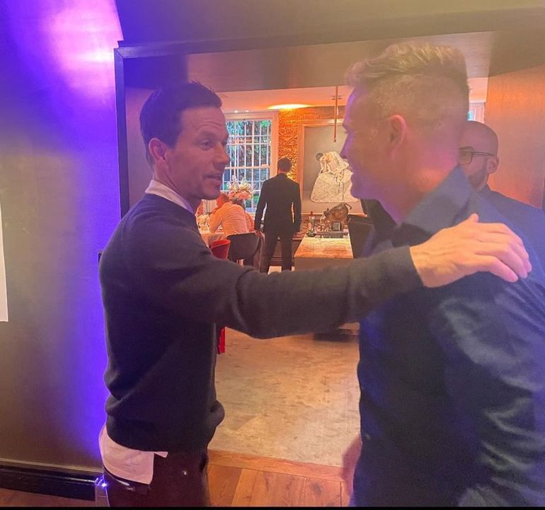 Mark Wahlberg embracing Nicky Byrne