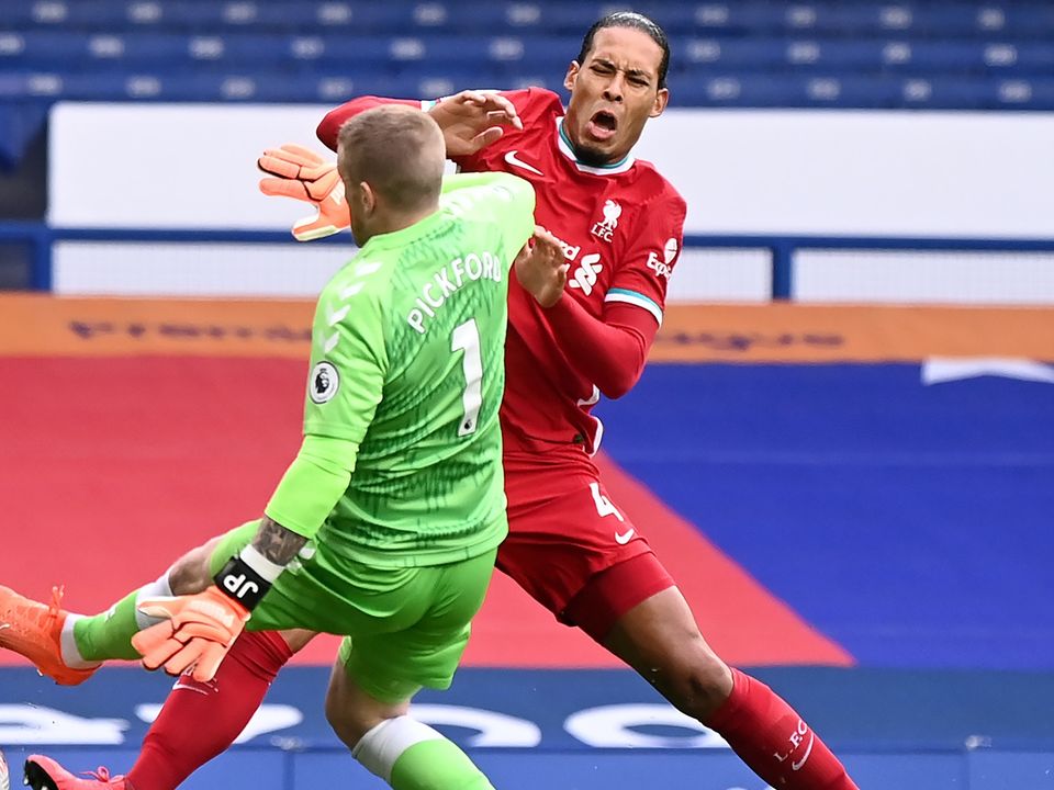 Liverpool’s Virgil van Dijk is challenged by Everton goalkeeper Jordan Pickford (Laurence Griffiths/PA)