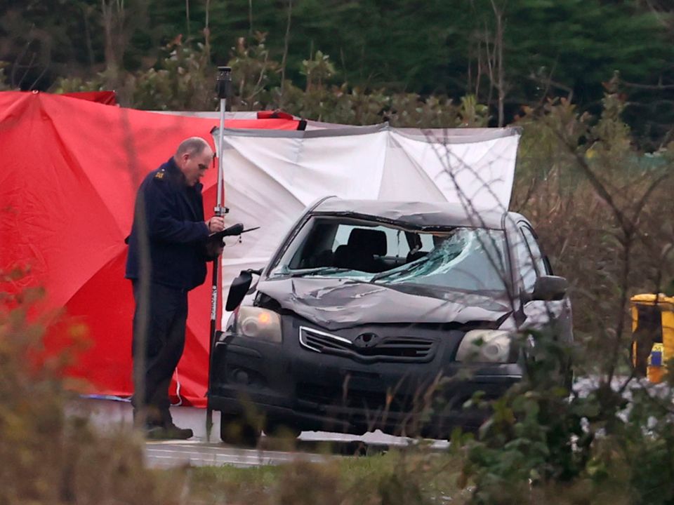 A forensic officer examines a car involved in a fatal accident at the Ballynacarry Bridge on the N53 in Co Monaghan on Thursday . Photo: Liam McBurney/PA