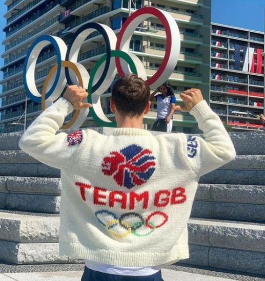 Tom Daley wearing an Olympic-themed cardigan he knitted at the Olympics in Tokyo (@madewithlovebytomdaley/PA)