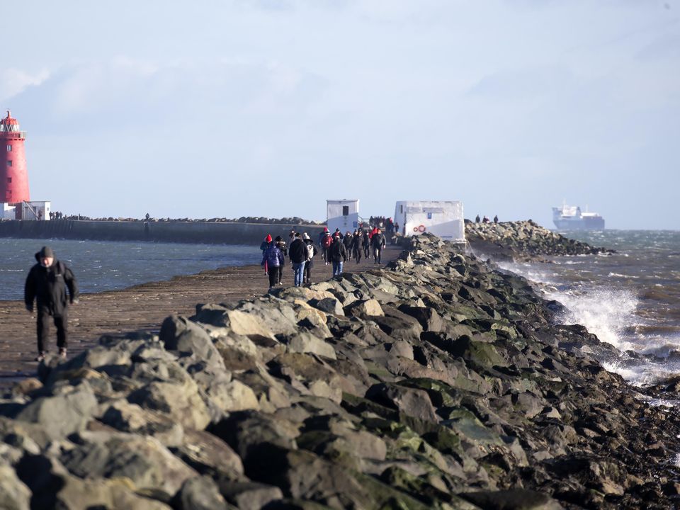 People out walking on the Great South Wall in Dublin. Picture: Collins