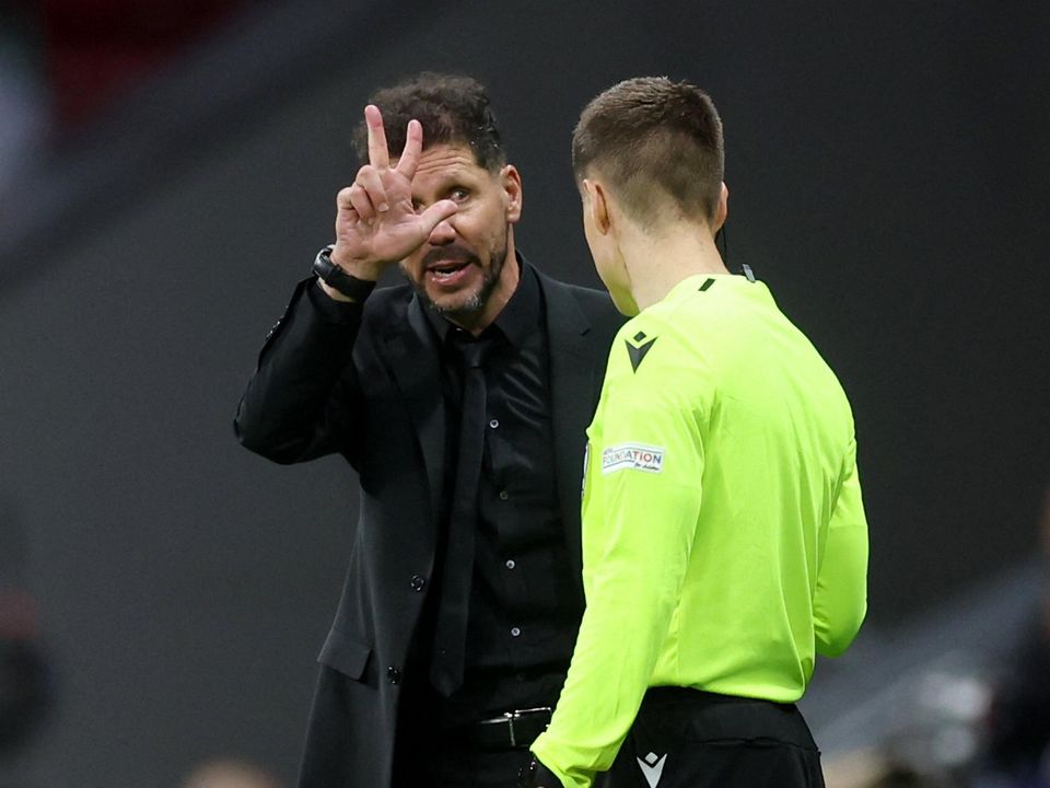 Diego Simeone gestures to the referee's assistant during Atletico Madrid's ill-tempered Champions League clash with Manchester City