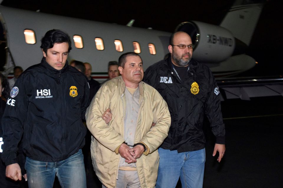 U.S. law enforcement authorities escort Joaquin ‘El Chapo’ Guzman (centre) from a plane