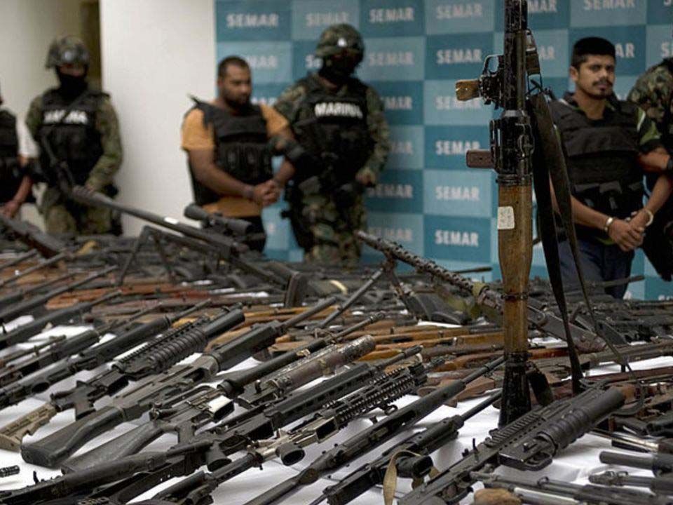 Police guard a massive collection of guns taken from drug cartels in Mexico