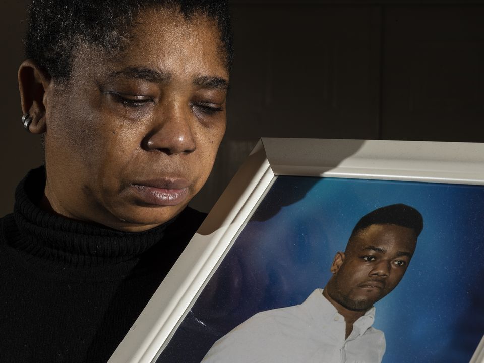 Blessing Nkencho with a photograph of her son George Enkencho, who was shot dead by gardai outside his home in December 2020. Picture by Gerry Mooney