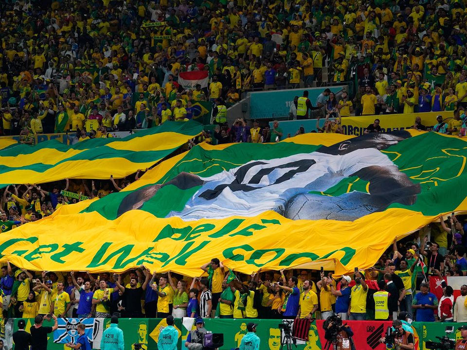 Fans in the stands with a giant Pele banner during the FIFA World Cup Group G match at the Lusail Stadium