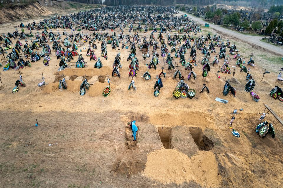 A grave digger prepares the ground for a funeral at a cemetery in Irpin, Ukraine (Photo by John Moore/Getty Images)