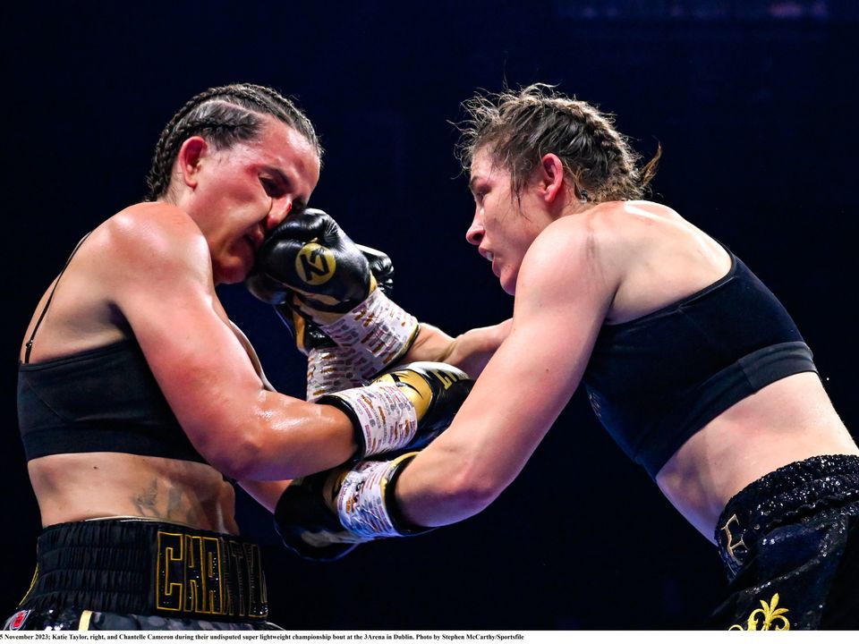 25 November 2023; Katie Taylor, right, and Chantelle Cameron during their undisputed super lightweight championship bout at the 3Arena in Dublin. Photo by Stephen McCarthy/Sportsfile