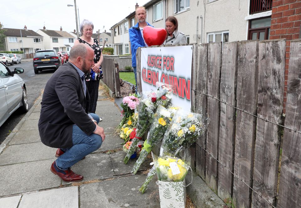 Martin Quinn, the brother of Glenn Quinn, with family members and friends leaves flowers outside the flat where Glenn lived and was murdered