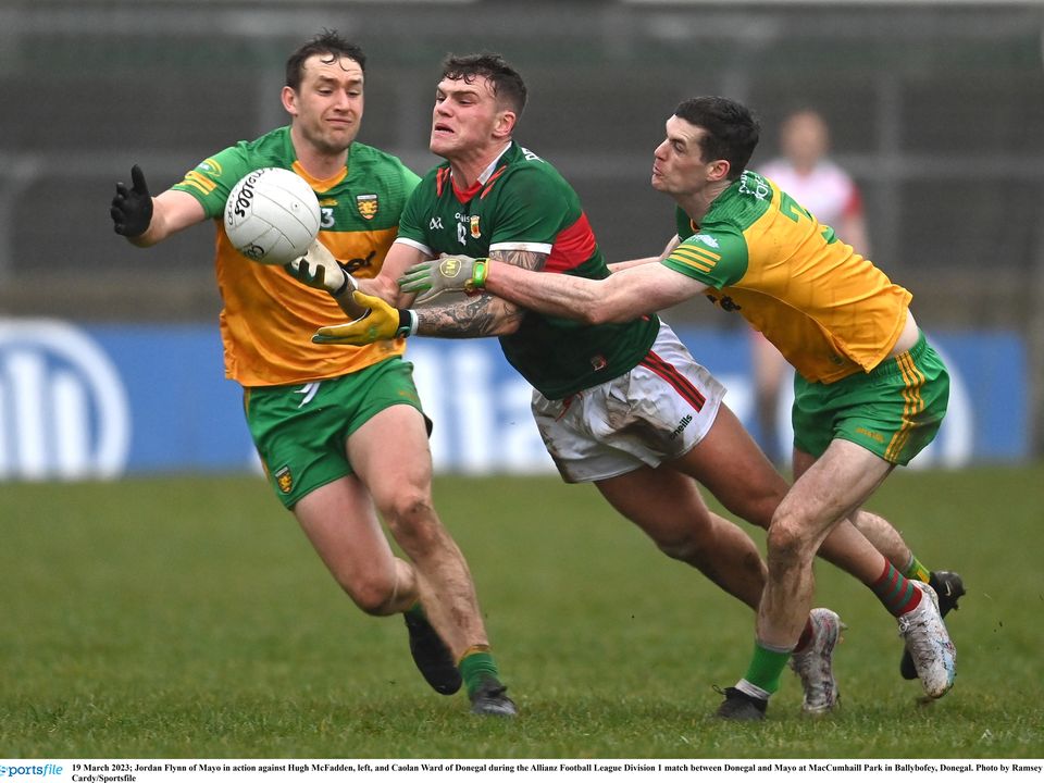 19 March 2023; Jordan Flynn of Mayo in action against Hugh McFadden, left, and Caolan Ward of Donegal during the Allianz Football League Division 1 match between Donegal and Mayo at MacCumhaill Park in Ballybofey, Donegal. Photo by Ramsey Cardy/Sportsfile