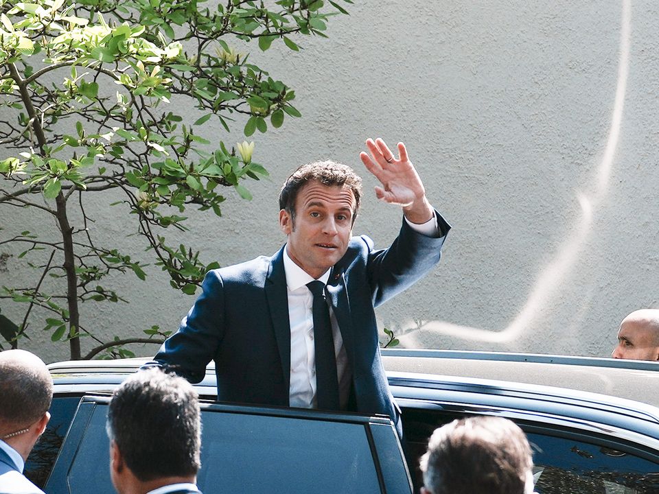French President and centrist candidate Emmanuel Macron waves from his car after casting his vote in Le Touquet (AP Photo/Thibault Camus)