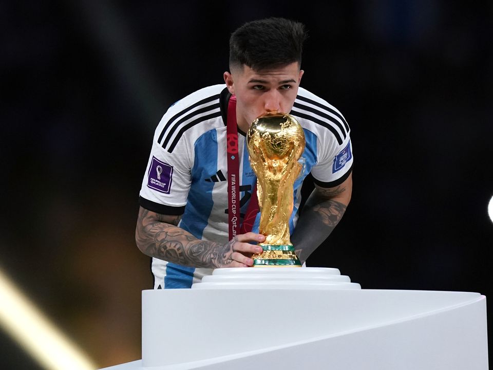Argentina's Enzo Fernandez kisses the World Cup trophy before the ceremony following FIFA World Cup final at Lusail Stadium, Qatar. Picture date: Sunday December 18, 2022.