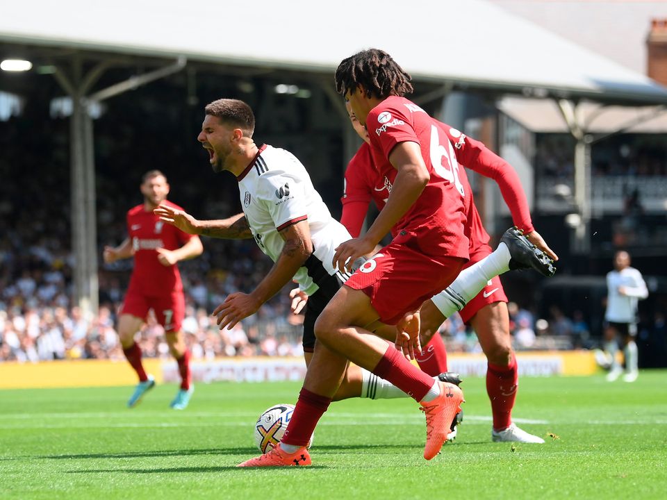 Aleksandar Mitrovic of Fulham is fouled by Virgil van Dijk and Trent Alexander-Arnold of Liverpool, which results in a penalty. Photo: Mike Hewitt/Getty Images