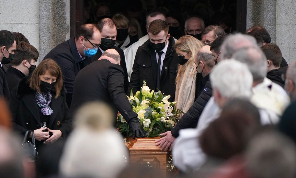 Family members place their hands on the coffin as it is carried out of St Brigid’s Church, Mountbolus, Co Offaly, after the funeral of Ashling Murphy (Niall Carson/PA)
