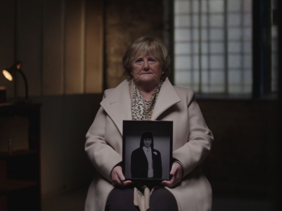 Ann Donnelly holds a photo of her brother, Marty, who was brutally murdered