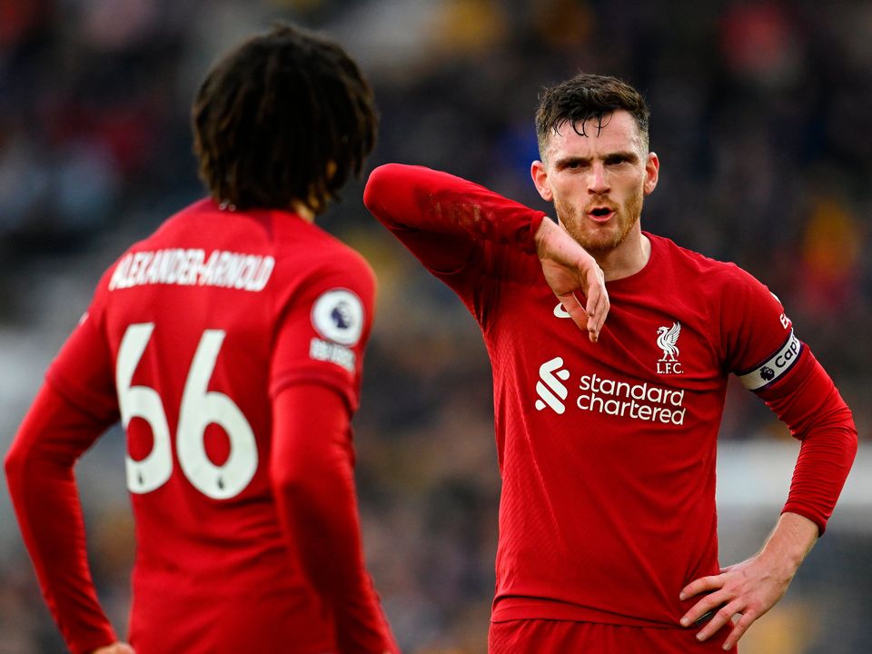 WOLVERHAMPTON, ENGLAND - FEBRUARY 04: Andrew Robertson of Liverpool reacts towards team mate Trent Alexander-Arnold during the Premier League match between Wolverhampton Wanderers and Liverpool FC at Molineux on February 04, 2023 in Wolverhampton, England. In a Premier League first, both sets of players, and match officials, will wear Green Football Weekend sustainable green armbands to highlight the initiative and put the conversation about climate change and sustainability on the world stage. (Photo by Clive Mason/Getty Images)