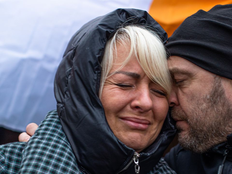 Kseniya Muraskova from Ukraine sheds a tear as she receives a red rose for International Women's Day from Aigars Joksts from Kimmage in Dublin at the refugee reception centre in Medyka, Poland (Photo: Mark Condren)