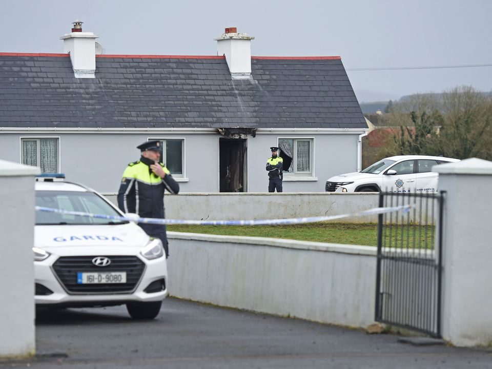Gardaí at a house in Castlebar where a man, John Brogan (82), was found murdered on Sunday. Photo: Conor McKeown