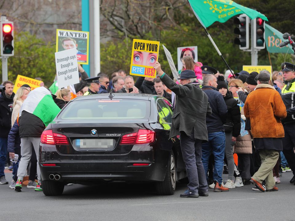 Protesters swarms around a car at RTÉ studios