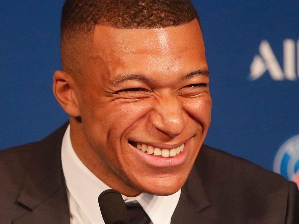 PSG striker Kylian Mbappe laughs during a press conference in Paris yesterday. Photo: AP