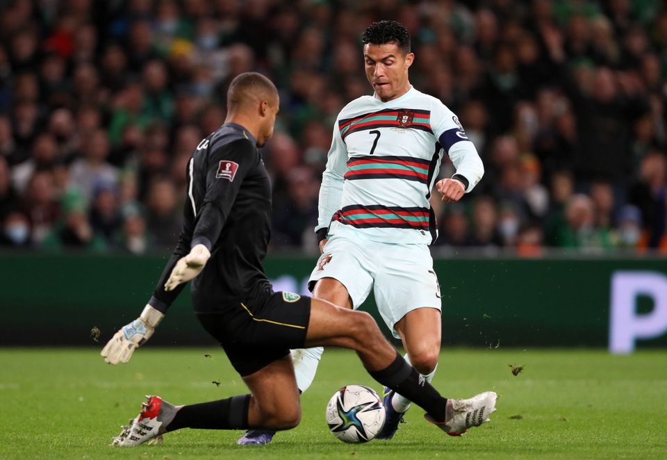Republic of Ireland goalkeeper Gavin Bazunu tackles Portugal’s Cristiano Ronaldo (Brian Lawless/PA)