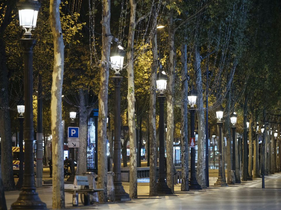 The Avenue des Champs-Elysees is deserted during the curfew in Paris (Lewis Joly/AP)