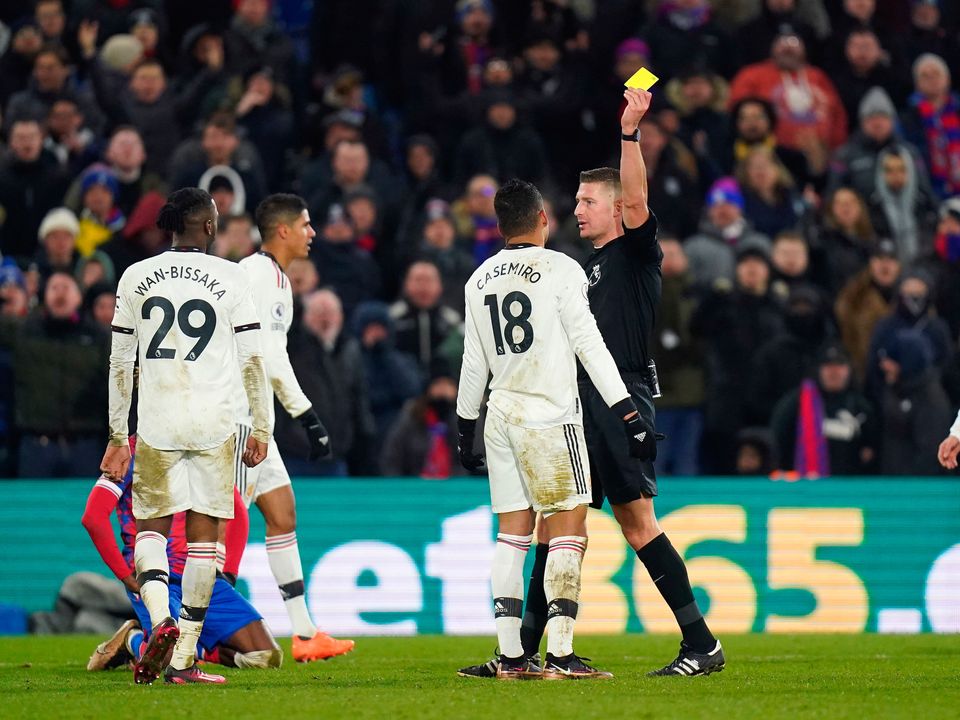 Manchester United's Casemiro is shown a yellow card by referee John Brooks against Palace, resulting in a suspension which will rules him out of today's game. Photo: Adam Davy/PA Wire.