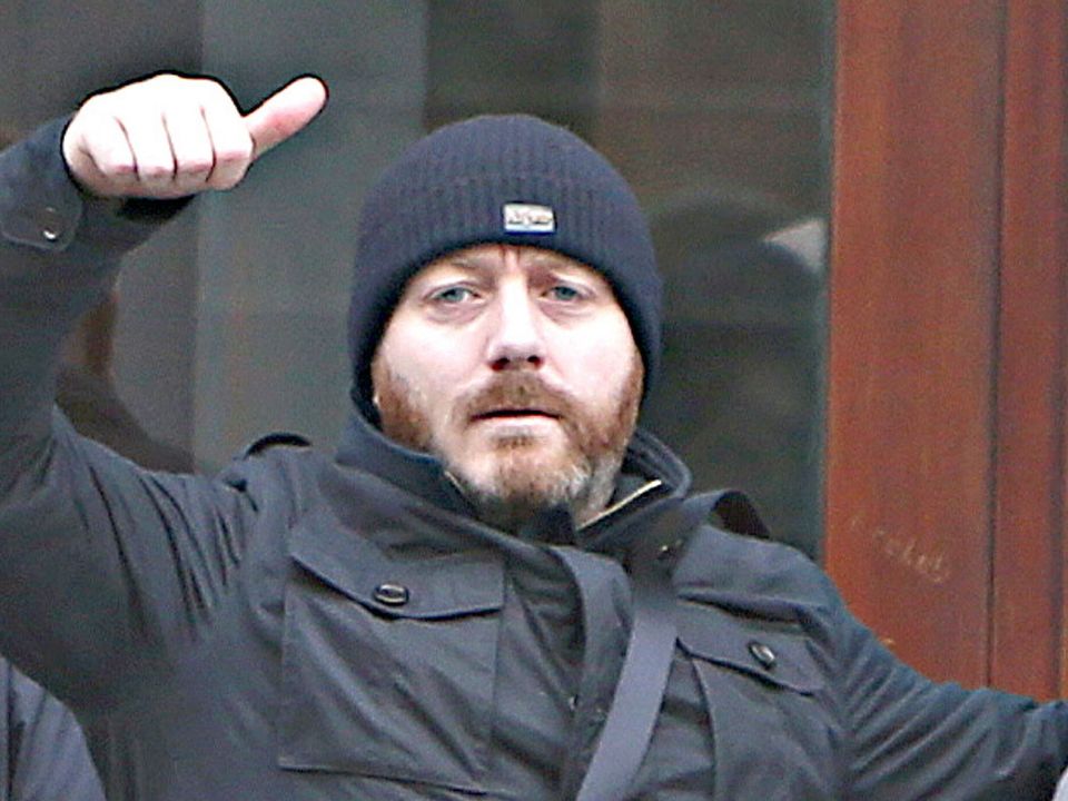 Freddie Thompson waves to photographers outside a Dublin court