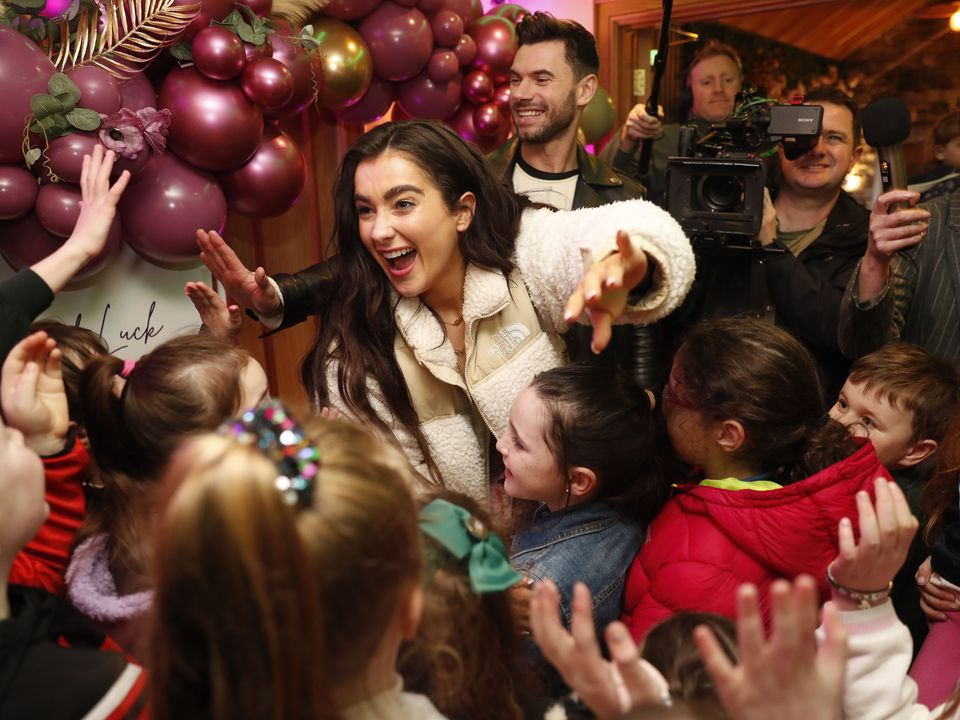 Brooke Scullion and her dancing partner Robert Rowinski are mobbed by fans and family members during a visit to Bellaghy. Photo: Peter Morrison