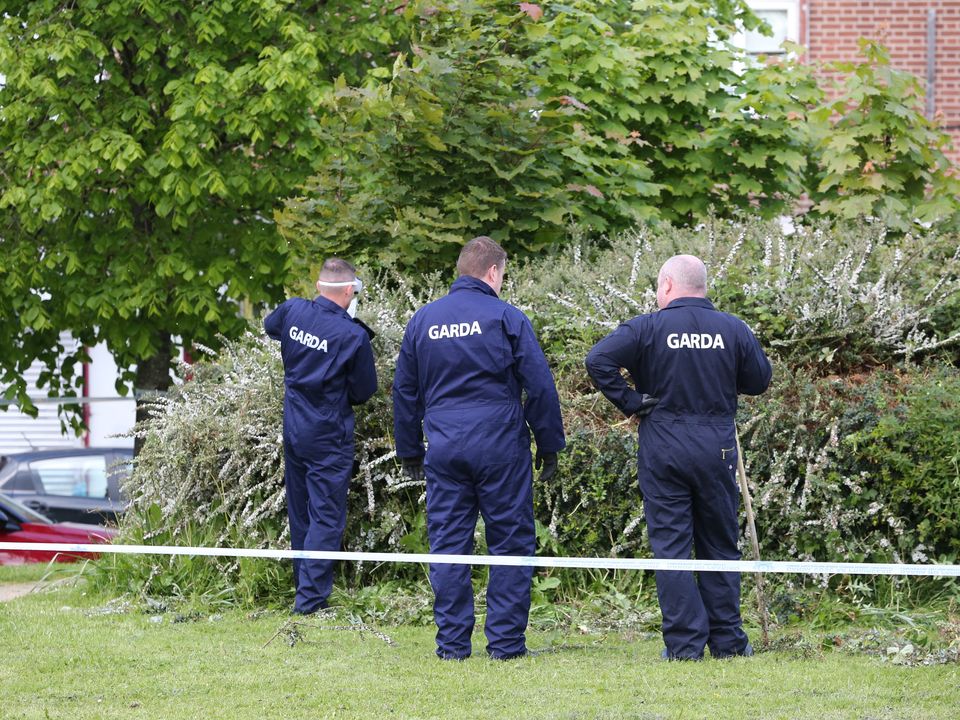 Gardaí searching the scene on La Touche Road in Bluebell, Dublin this morning.(Pic Gareth Chaney/Collins Photos)