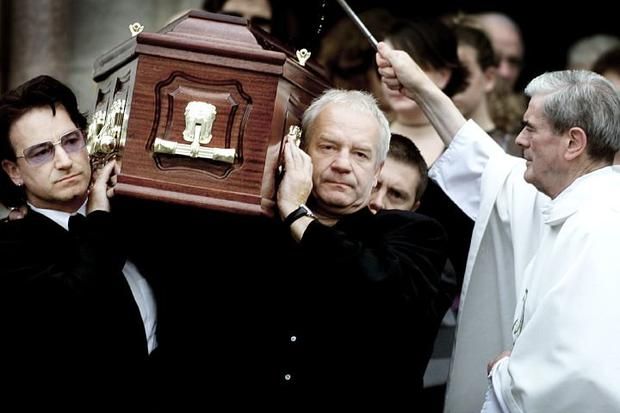 Bono and his brother Norman carry their father Bob's coffin.
