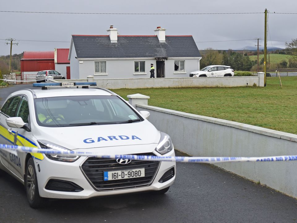 Garda attend the scene of the house at Pheasanthill, Castlebar, where John Brogan was found dead on Sunday evening. Photo: Conor McKeown