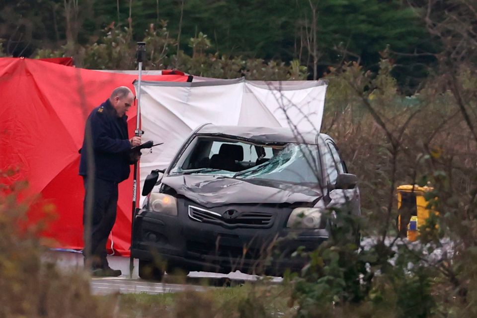 A forensic officer examines a car involved in a fatal accident at the Ballynacarry Bridge on the N53 in Co Monaghan on Thursday . Photo: Liam McBurney/PA