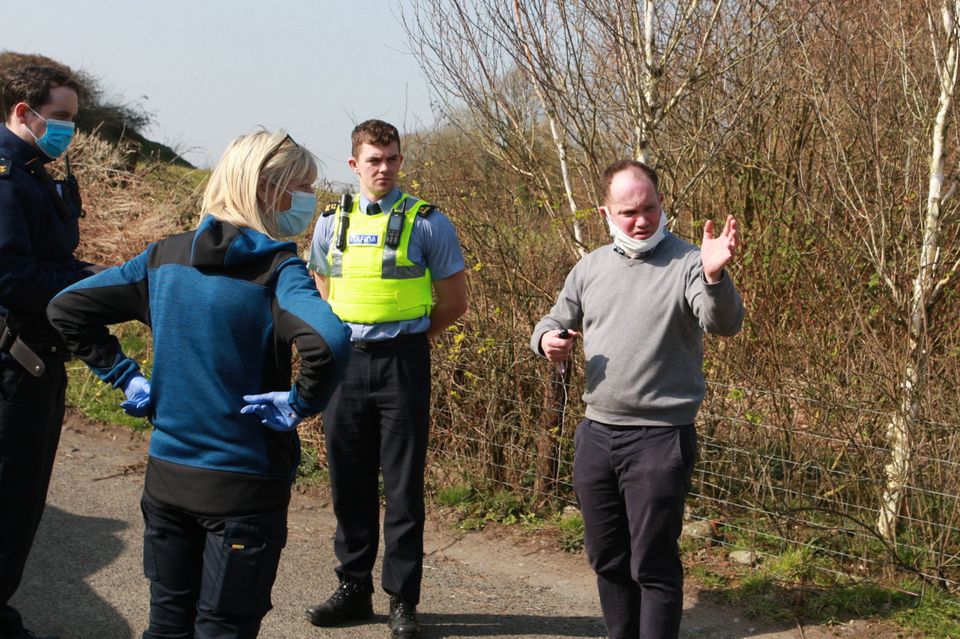 James Mahon (in grey jumper),who is the son of Maureen, with gardaí and dog warden