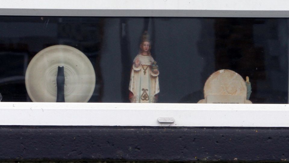 A child of prague statue, sits in the front window of  former Eucharistic Minister Bernard McNamee, home address.
McNamee 62,  was recently found guilty of historic sexual abuse of a friends child.

