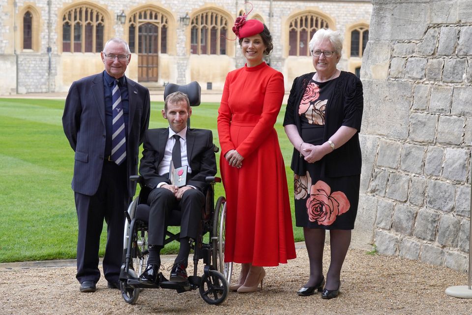Robert Burrow (second from left) with (from left to right) father Geoff Burrow, wife Lindsey and mother Irene after he was made an MBE by the Princess Royal (Steve Parsons/PA)