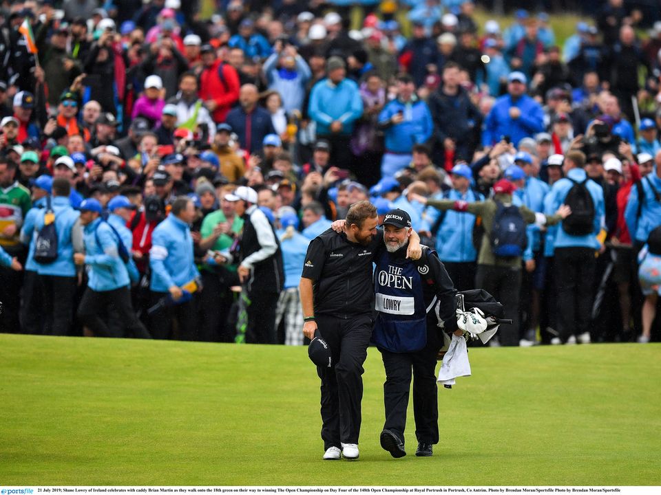 Shane Lowry celebrates his first major title with caddy Brian Martin at Royal Portrush in 2019