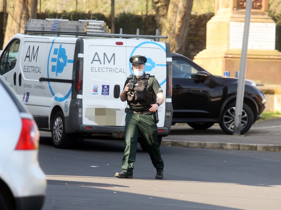 Police at the scene as Irish Foreign Minister Simon Coveney has been moved out of a building in north Belfast amid a security alert. Pic Pacemaker