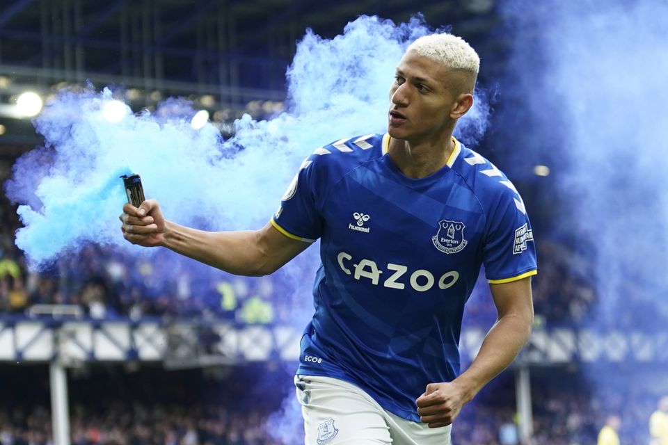 Richarlison runs with a smoke canister as he celebrates scoring for Everton against Chelsea (Jon Super/PA)