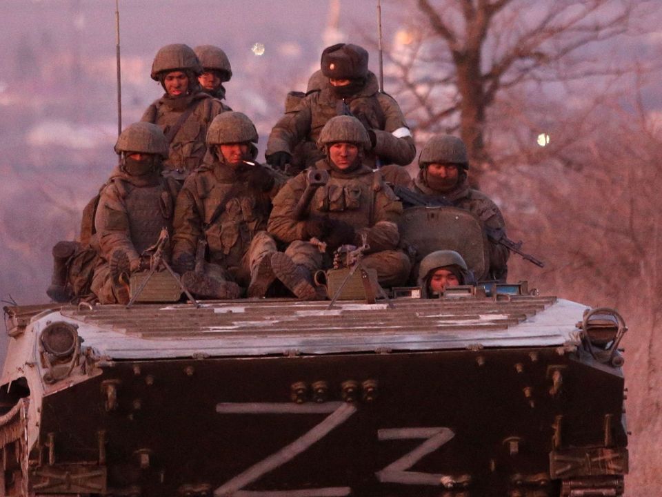 Pro-Russian troops are seen on an armoured vehicle on a road leading to the besieged southern port city of Mariupol, Ukraine. Picture: Reuters