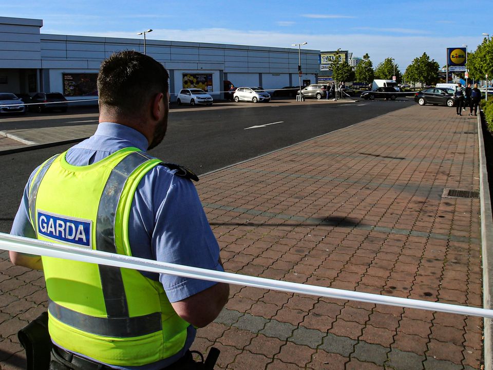 Garda investigators search a shopping centre car park on St Margaret’s Road in Finglas following the shooting incident