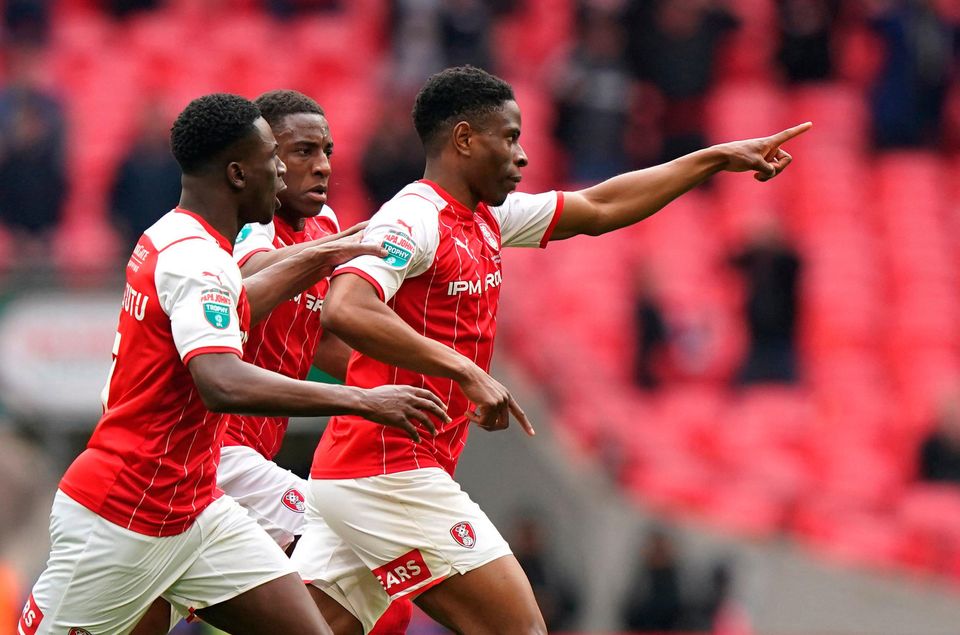 Rotherham United's Chiedozie Ogbene (right) celebrates scoring their side's third goal of the game in extra-time during the Papa John's Trophy final at Wembley Stadium, London