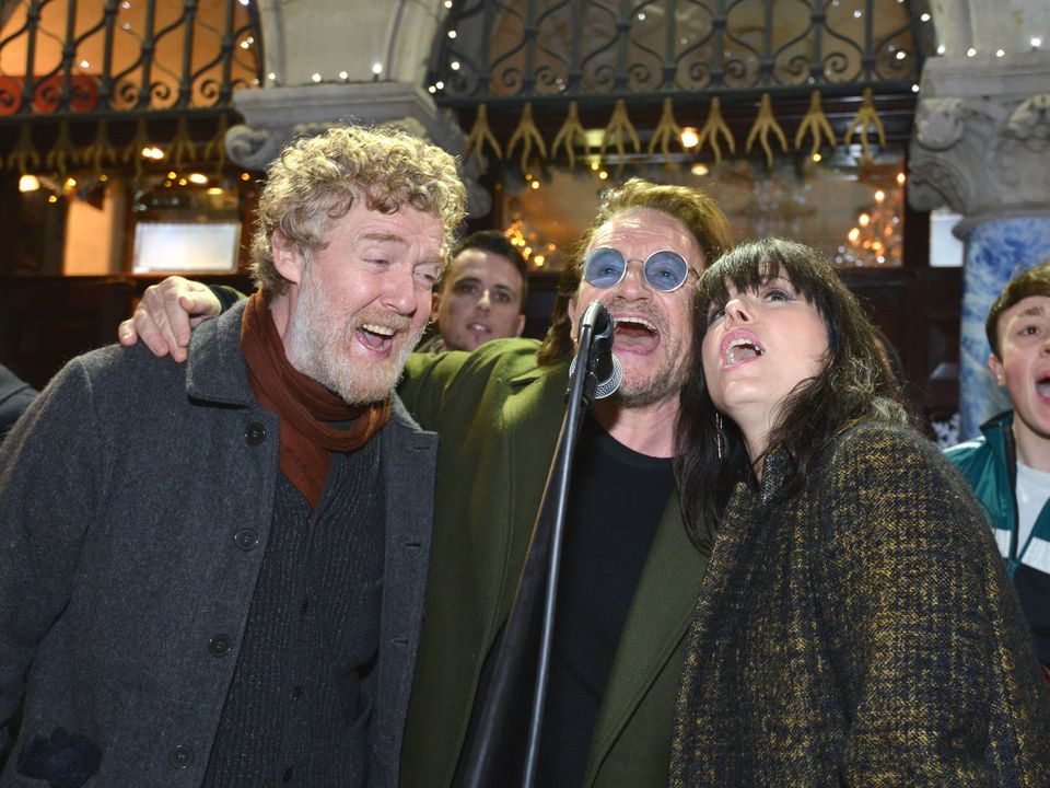 Oscar winner Glen Hansard, Bono from U2 and Imelda May entertain last minute shoppers during the annual Christmas Eve busk for the homeless in Dublin city centre, Photo credit: Barbara Lindberg.